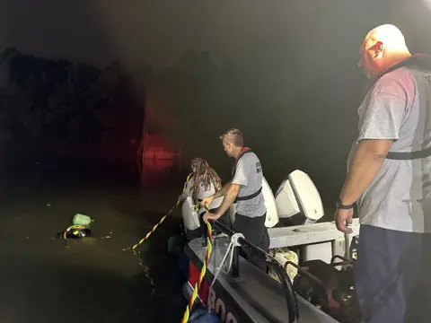 Night operations: Crew members preparing search operations under flashlight illumination.